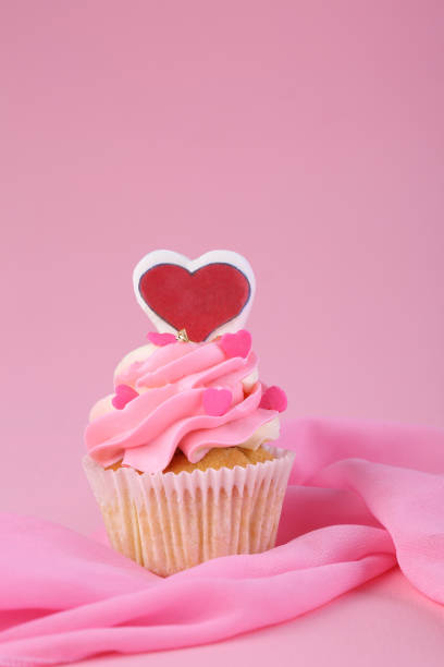 istock Cupcakes on pink background. Closeup 1202732789