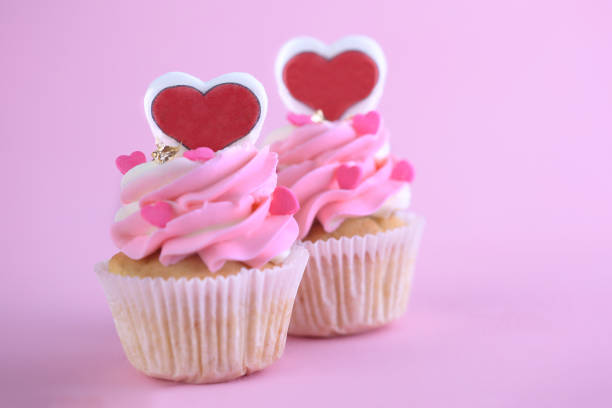 istock Cupcakes with hearts on pink background. Closeup 1202732833
