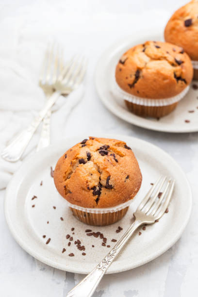 istock muffins with chocolate on white dish on ceramic background 1202739797