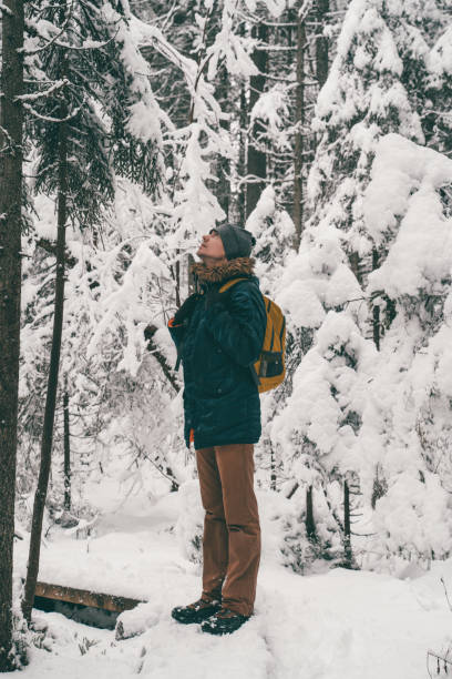 istock Full-length image of man in winter forest. 1202740184