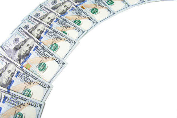 istock Banknotes of dollars are stacked in a row 1202740439