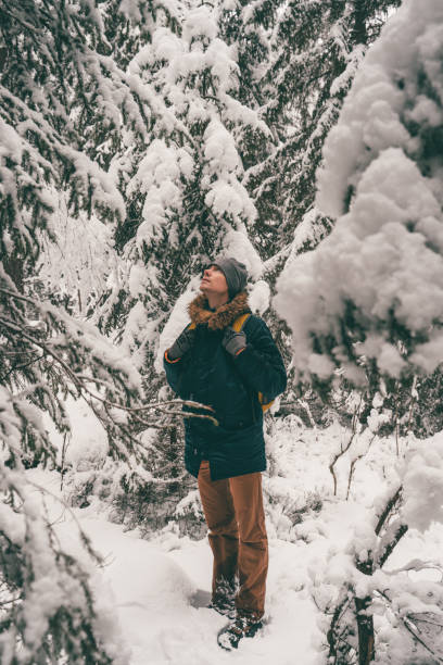 istock Full-length image of man in winter forest. 1202741409