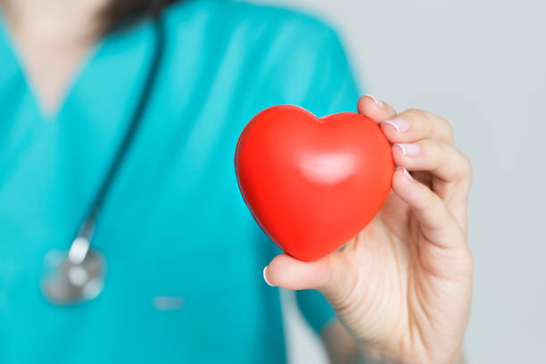 istock Doctor Holding Red Heart Shape in Hand 1202741976
