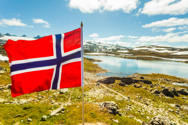 istock Norwegian flag and mountains snowy landscape 1202742629