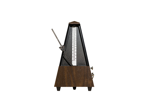 old, analog metronome, isolated against a light background with space for text