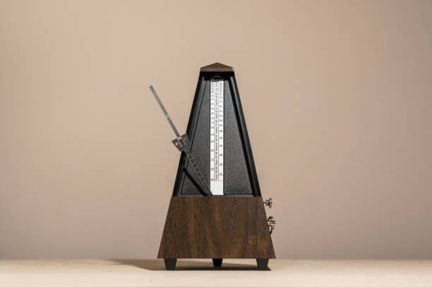 analog metronome, isolated against a concrete background stock photo