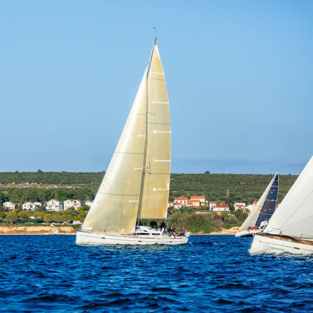 Sailing crew on sailboat at starting line on regatta. Models and event regatta property released.