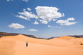 Asian woman alone in desert, Coral Pink Sand Dunes, Utah