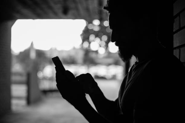 istock Man in the dark using his mobile phone 1202744140