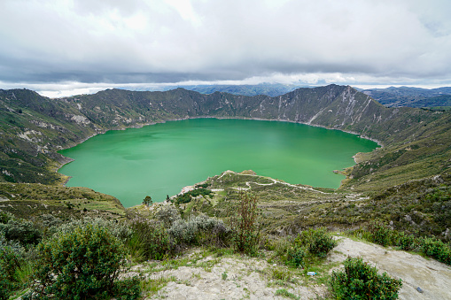 Quilotoa volcano lake is 3ooo m wide, about 250 deep and on the Elevation 3,914 m. The greenish color coms from dissolved minerals and it is touristic destination with hiking down to the lake.