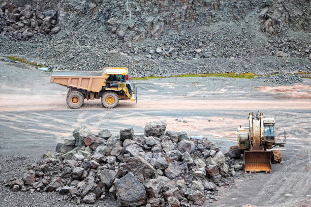 istock dumper truck driving in a mining pit. quarry. 1202744518