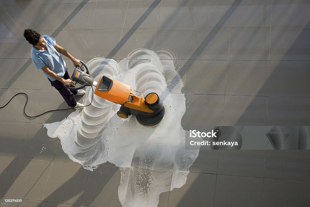 cleaning A worker is cleaning the floor with machine Cleaning Stock Photo