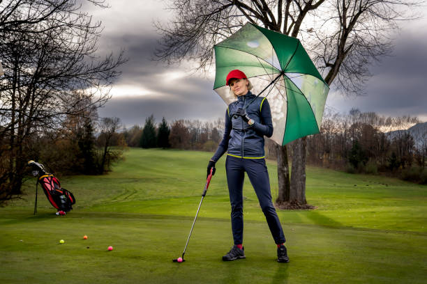 mature female model at golf course - baseball cap cap hat golf hat imagens e fotografias de stock
