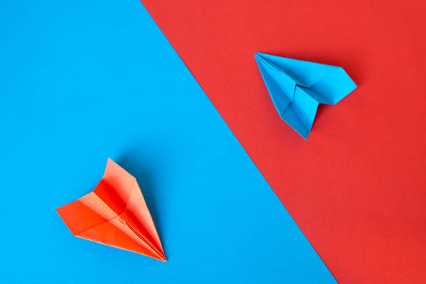 Paper plane on blue and red paper