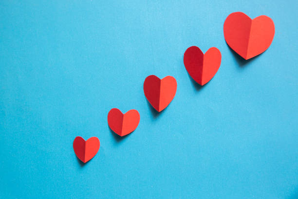 istock Red heart shaped paper on blue background;Valentine day card concept 1202747366