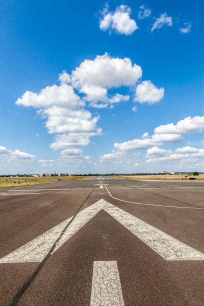 istock Close up airport runway against blue cloudy sky 1202748819