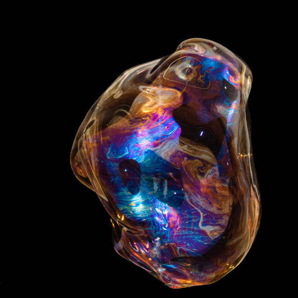 istock Colorful creative amorphous soap bubble floating with a black background 1202748928