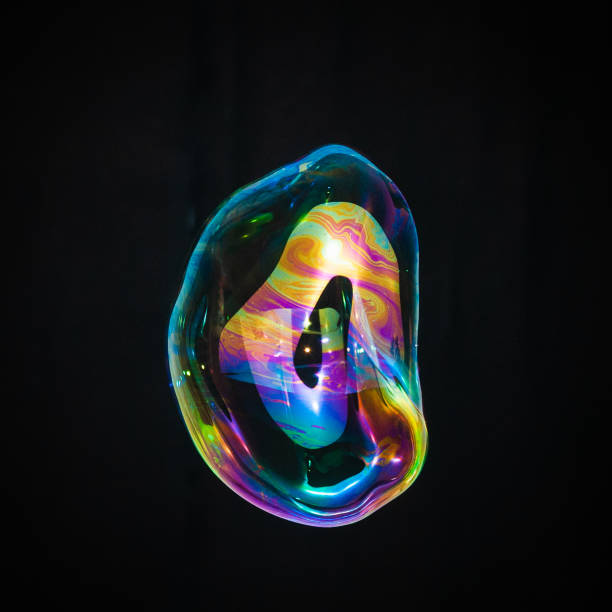 istock Colorful creative amorphous soap bubble floating with a black background 1202749027