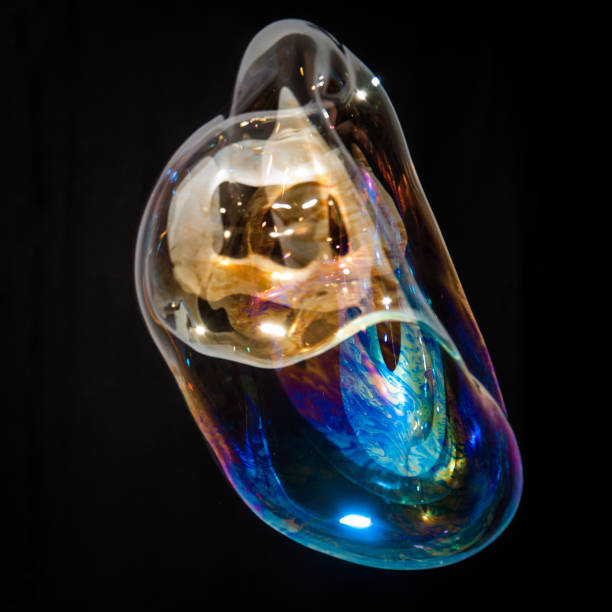 istock Colorful creative amorphous soap bubble floating with a black background 1202749036