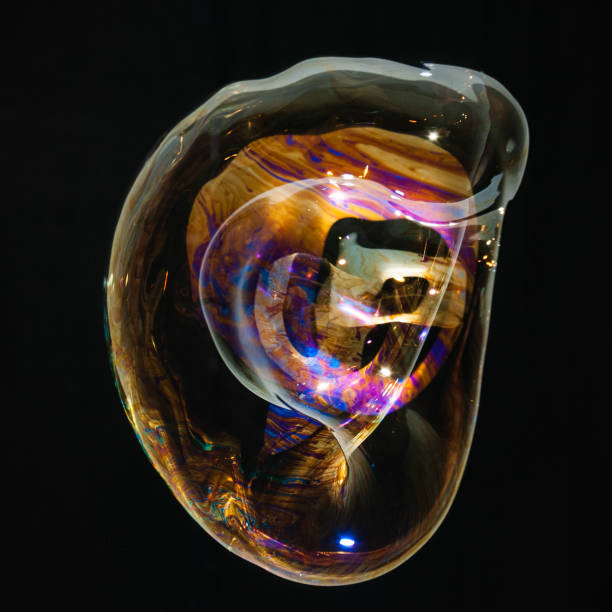 istock Colorful creative amorphous soap bubble floating with a black background 1202749074
