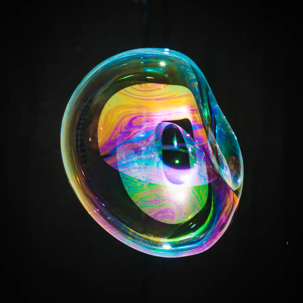 istock Colorful creative amorphous soap bubble floating with a black background 1202749080