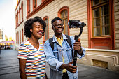 Young smiling youtubers making a video.