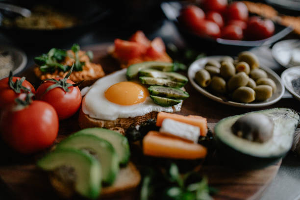 istock Preparing avocado and cherry tomato toast and bruschetta 1202752521