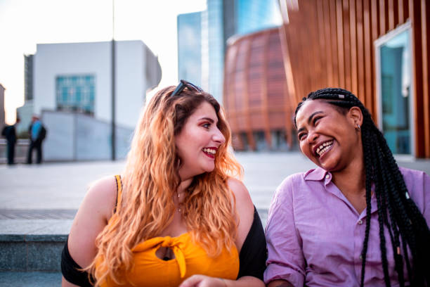 istock Two beautiful friends laughing 1202752797