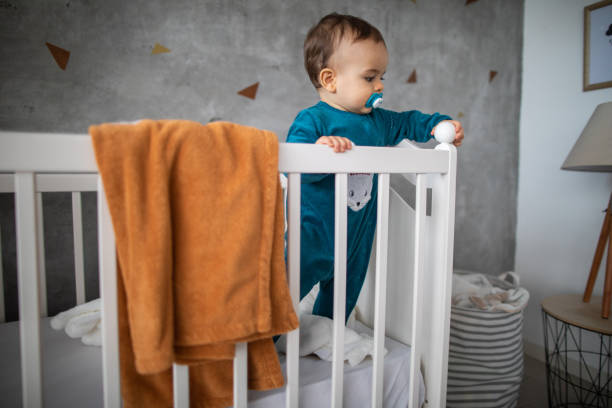 istock Baby boy playibg with baby bed 1202752844