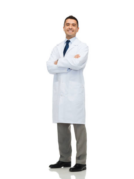 smiling male doctor in white coat - full length imagens e fotografias de stock