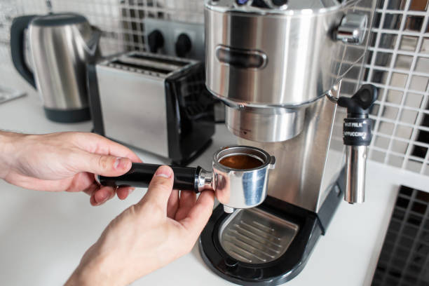 istock Guy prepare delicious aromatic coffee in a coffee machine. A simple way to make coffee 1202755097