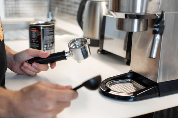 istock Guy prepare delicious aromatic coffee in a coffee machine. A simple way to make coffee 1202755100