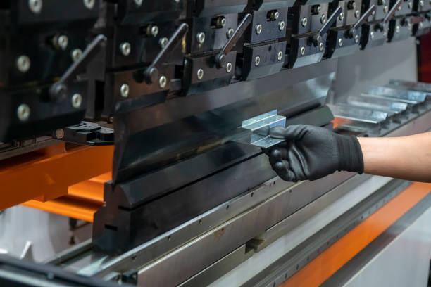 istock Operation of press brake hydraulic bending machine with forming die by skill operator. 1202755615