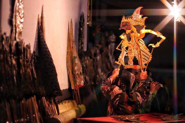 Wayang Indonesian performance art in Magelang traditional night festival. “Magelang, Indonesia – October 04, 2019 : 
Wayang Indonesian performance art in Magelang traditional night festival. Wayang is a native Indonesian performance art that is growing rapidly in Java and Bali.  The show is also popular in areas such as Sumatra and the Malay Peninsula, and also has a number of wayang cultures that are influenced by Javanese and Hindu culture." wayang kulit photos stock pictures, royalty-free photos & images