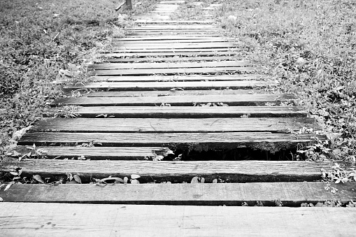 old and dirty broken wood bridge on walk way in black and white photography
