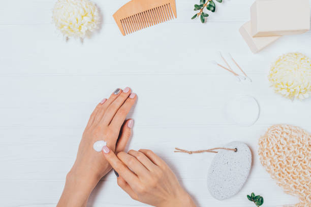 istock View from above woman's hands applying cosmetic cream 1202758877