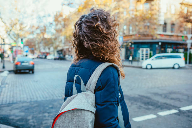 istock Rear view young woman with backpack 1202758904