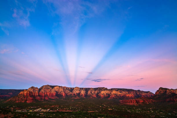 Dramatic anticrepuscular rays at sunset over the red rocks in Sedona, Arizona.