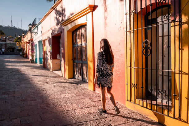 Young woman walking the streets of Oaxaca city Young woman walking the streets of Oaxaca city oaxaca city photos stock pictures, royalty-free photos & images