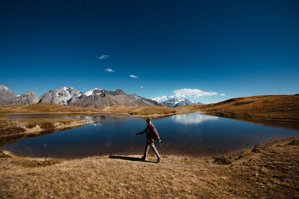 istock Man is passing by a lake in the Caucasus Mountains 1202763860