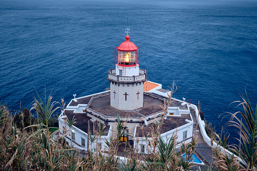 Lighthouse Arnel on the shore of the Atlantic Ocean. Sao Miguel Island, Azores, Portugal.