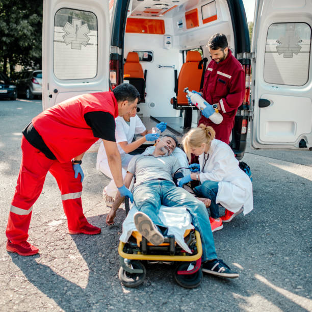 istock Doctor and paramedics helping mature man 1202765341