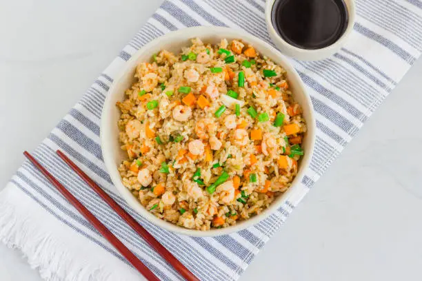 Chinese Shrimp Fried Rice, Popular Chinese Take Out Food, in a Bowl with Chopsticks, Top View Photo
