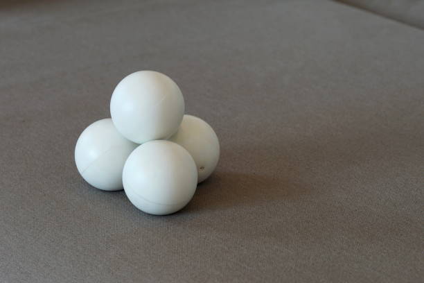 istock White juggling balls on a grey sofa 1202768297