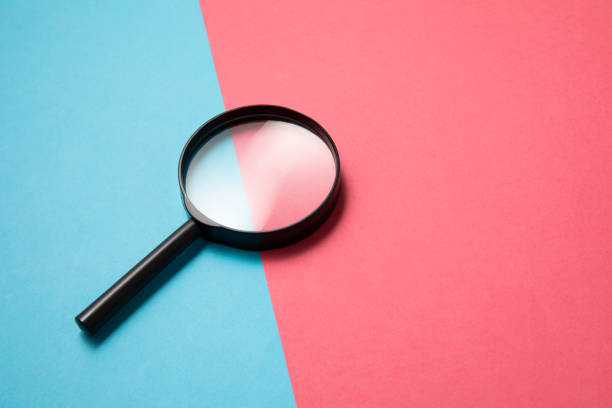 istock Magnifying Glass on Two Tone Color Background 1202769397