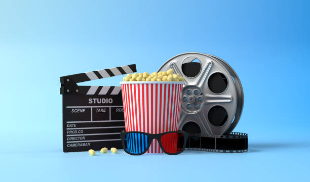 istock Popcorn, 3D glasses, film reel and clapboard on a blue background 1202770155