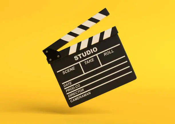 Flying lapperboard isolated on bright yellow background in pastel colors. Minimalist creative concept. Cinema, movie, entertainment concept. 3d render illustration