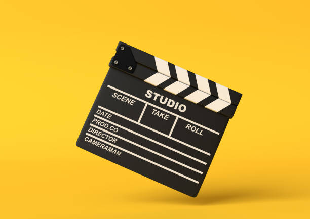istock Flying lapperboard isolated on bright yellow background in pastel colors 1202770176