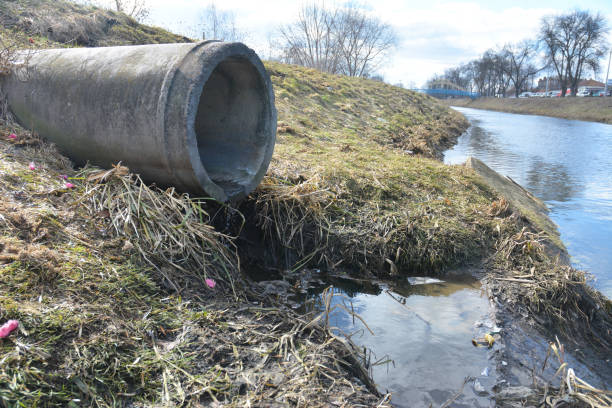 istock Polluted dirty water stems from the pipe into the river. Water pollution. 1202770313