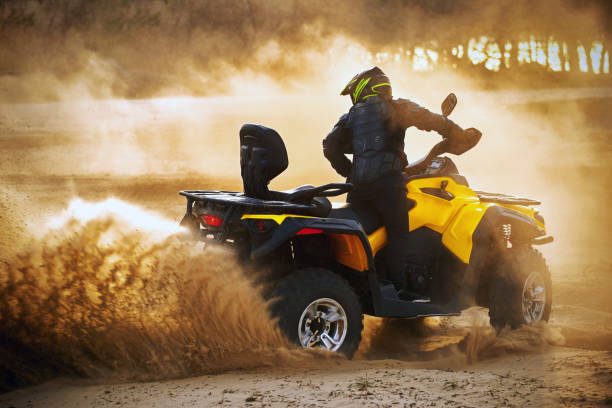 istock Racing powerful quad bike on the difficult sand in the summer. 1202771286